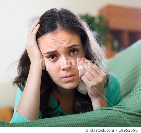Lonely woman crying on couch 19952550
