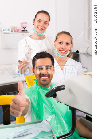 Contented patient at dentist office. Contented patient at dentist office. 19952563