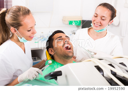 Patient is examined at dental clinic Patient is examined at dental clinic 19952590
