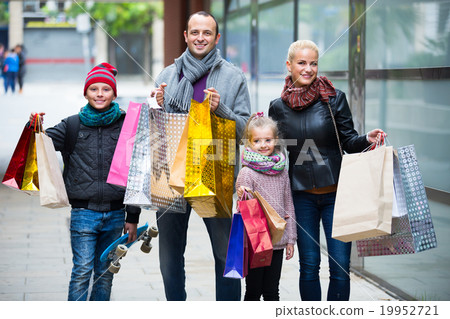couple with kids on city street couple with kids on city street 19952721