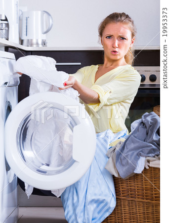 Young woman holding stained linen Young woman holding stained linen 19953373