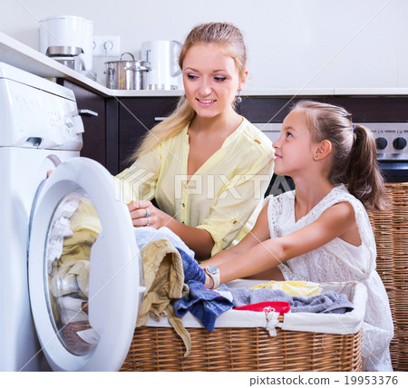 Housewife and girl doing laundry 19953376