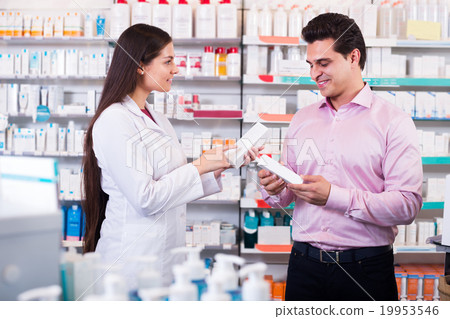Pharmacist and consulting man in pharmacy Pharmacist and consulting man in pharmacy 19953546