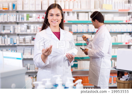 Portrait of two friendly pharmacists working Portrait of two friendly pharmacists working 19953555