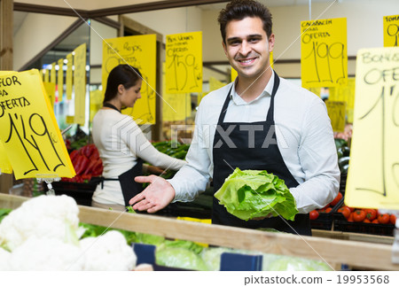 shop people standing near cabbage in grocery shop people standing near cabbage in grocery 19953568