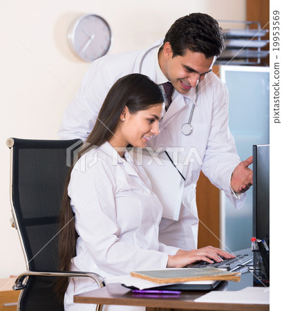 Two professional doctors brainstorming and sharing information Two professional doctors brainstorming and sharing information 19953569