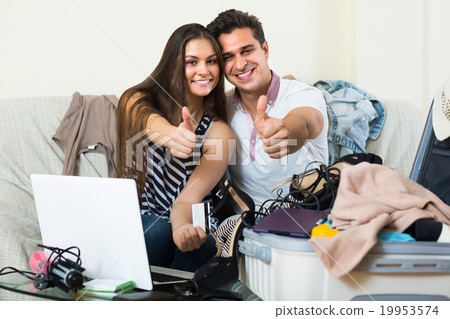 Happy couple buying tickets online. Happy couple buying tickets online. 19953574