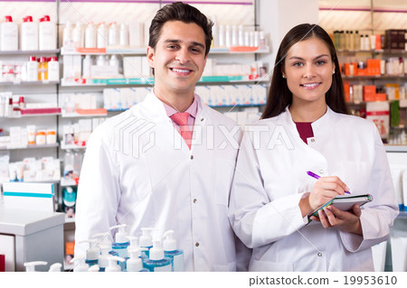 Portrait of two friendly pharmacists working 19953610
