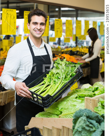 shop people standing near cabbage in grocery 19953655