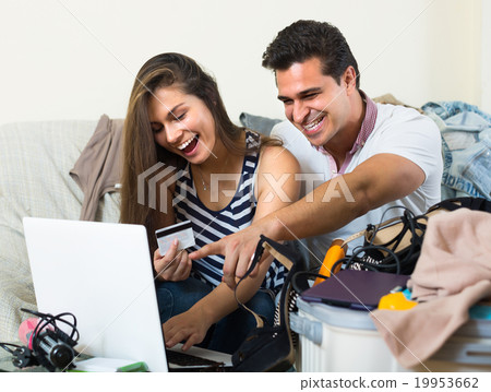 Couple preparing for voyage at home. Couple preparing for voyage at home. 19953662