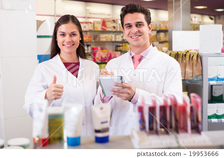 pharmacists posing in drugstore pharmacists posing in drugstore 19953666
