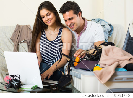 Couple with notebook and credit card. Couple with notebook and credit card. 19953760