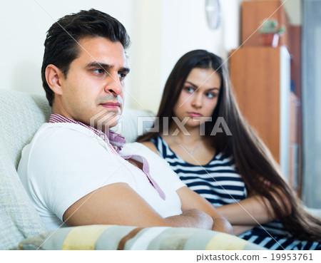 Quarrel between young spouses at home. 19953761