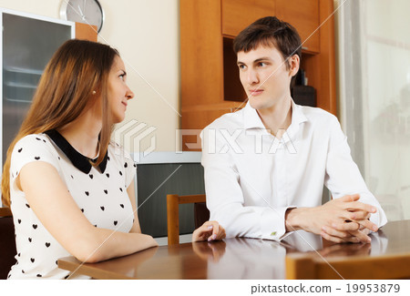 Casual young couple having serious talking 19953879