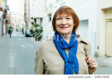 smiling senior woman at town street 19953949