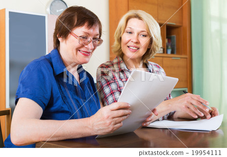 Notary officer helping aged client Notary officer helping aged client 19954111