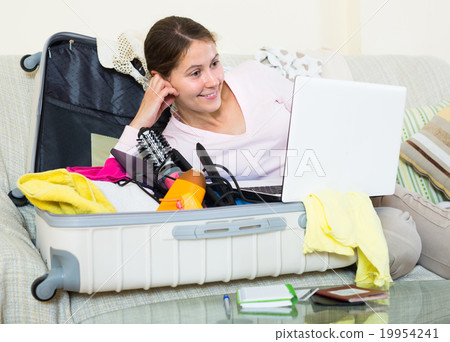 brunette planning vacation with notebook brunette planning vacation with notebook 19954241