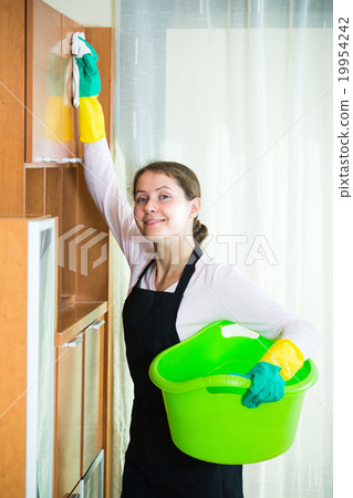 Female cleaner working indoors. Female cleaner working indoors. 19954242