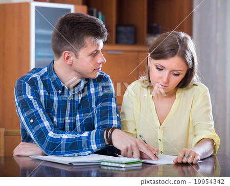 Spouses with documents for bank at home. 19954342