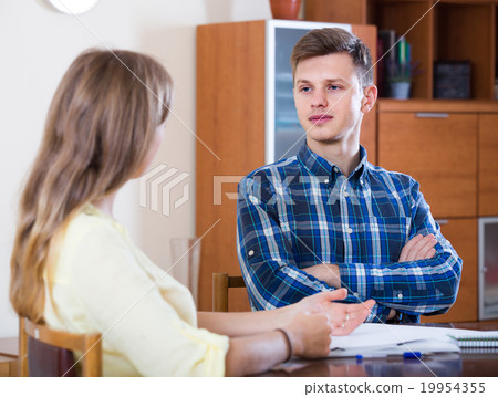 family couple at desk with financial documents indoors 19954355