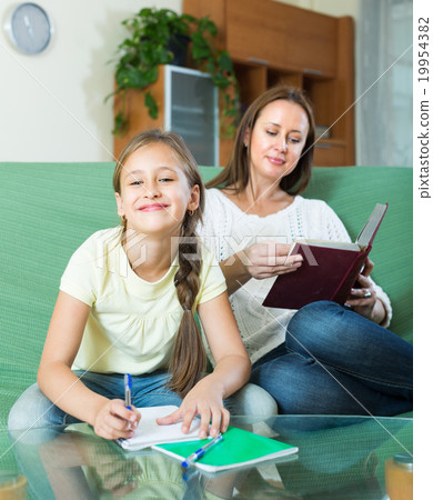 Mother with daughter doing homework Mother with daughter doing homework 19954382
