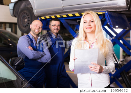 Woman and two auto mechanics 19954652