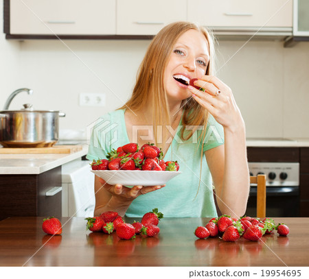 long-haired woman eating strawberry long-haired woman eating strawberry 19954695