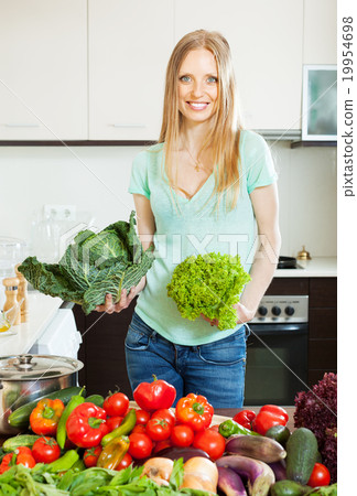 Blonde beautiful housewife cooking with vegetables Blonde beautiful housewife cooking with vegetables 19954698