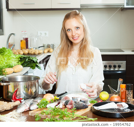 woman cooking saltwater fish in flour woman cooking saltwater fish in flour 19954762