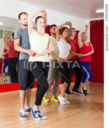 Group of people dancing salsa in studio 19954898