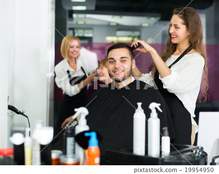 Woman hairdresser doing hairstyle Woman hairdresser doing hairstyle 19954950