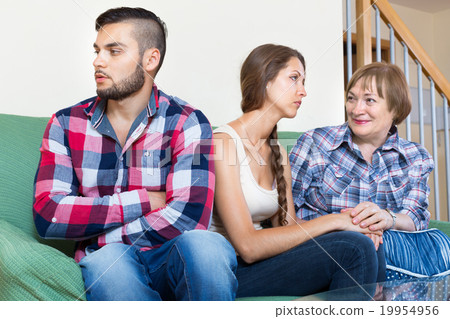 Mother comforting sullen daughter 19954956