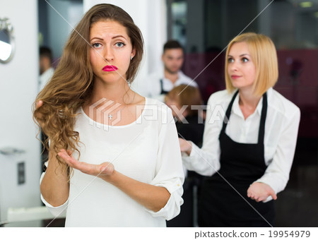 Displeased client and hairdresser. 19954979