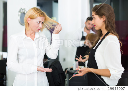 Displeased client and hairdresser. Displeased client and hairdresser. 19955007
