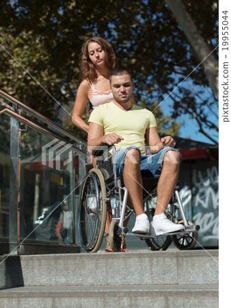 Man in invalid chair Man in invalid chair 19955044