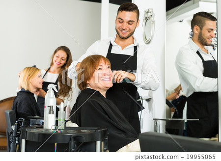 Woman cuts hair at the hair salon Woman cuts hair at the hair salon 19955065