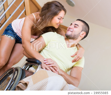Loving girl with her boyfriend in wheelchair Loving girl with her boyfriend in wheelchair 19955085