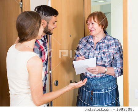 Woman and young family at door Woman and young family at door 19955093