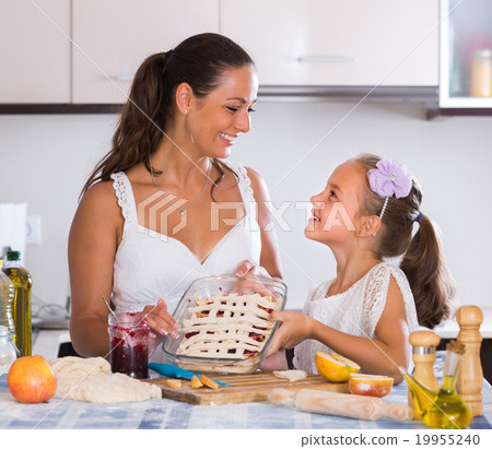 Housewife with daughter cooking apple pie. 19955240