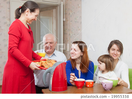 n family communicate over tea with cakes at home 19955338