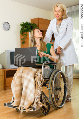 Social worker and invalid with laptop Social worker and invalid with laptop 19955528
