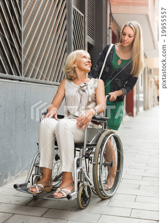Social worker and disabled woman at stroll Social worker and disabled woman at stroll 19955557