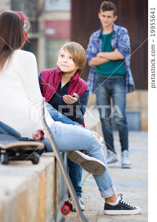 teen and his friends after conflict outdoors teen and his friends after conflict outdoors 19955641