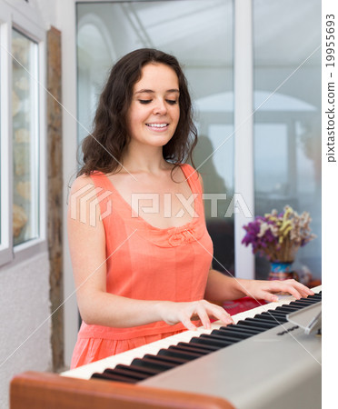 Female musician playing sequencer 19955693