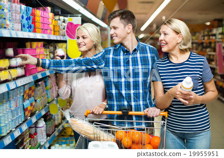 Ordinary happy family choosing dairy products 19955951