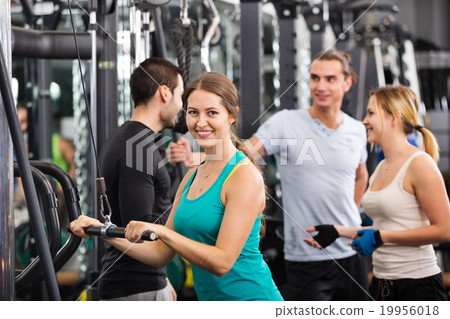 Adults doing powerlifting on machines 19956018