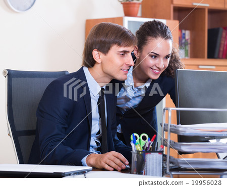 two happy employees in office 19956028