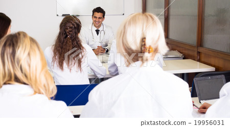 Multinational interns and professor having discussion Multinational interns and professor having discussion 19956031