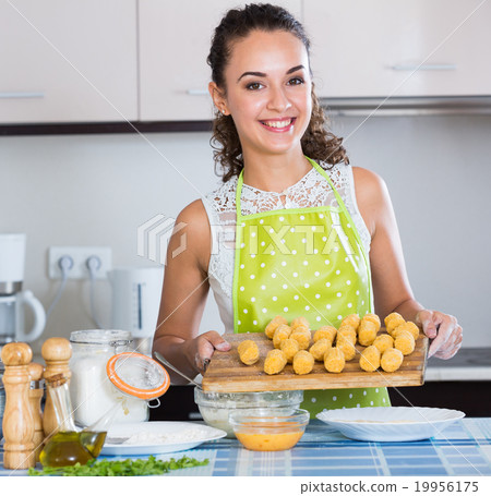 girl preparing croquettes for tasty dinner 19956175