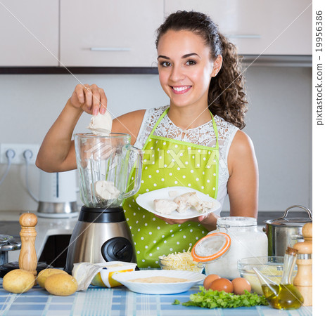 Woman with blender at kitchen. Woman with blender at kitchen. 19956386